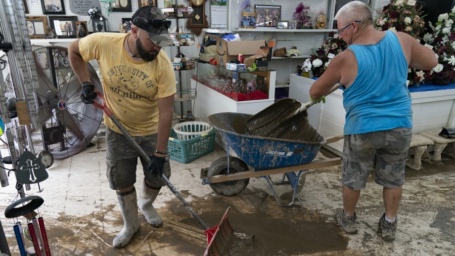 Volunteers help remove flood debris from Messenger Florist and Gifts in Whitesburg, Kentucky on Friday, Aug. 5, 2022.