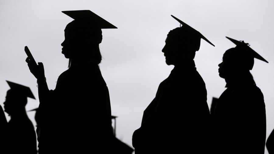 FILE - New graduates line up before the start of a community college commencement in East Rutherford, N.J., May 17, 2018. A federal judge in St. Louis on Thursday, Oct. 20, 2022, dismissed an effort by six Republican-led states to block the Biden administration's plan to forgive student loan debt for tens of millions of Americans. (AP Photo/Seth Wenig, File)