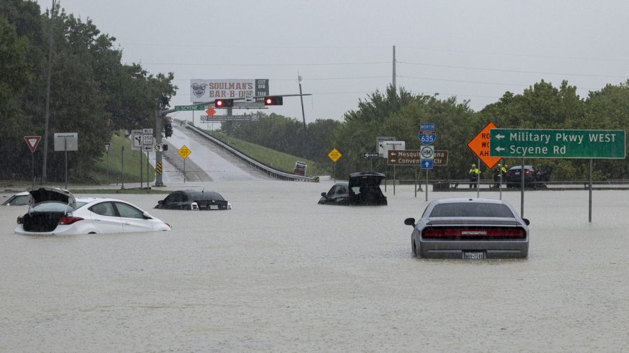 Stalled cars sit abandoned on the flooded Interstate 635 Service Road on Monday, Aug. 22, 2022, in Mesquite, Texas. The National Weather Service issued a flash flood warning early Monday morning which was extended until 1 p.m. (Elías Valverde II/The Dallas Morning News via AP)