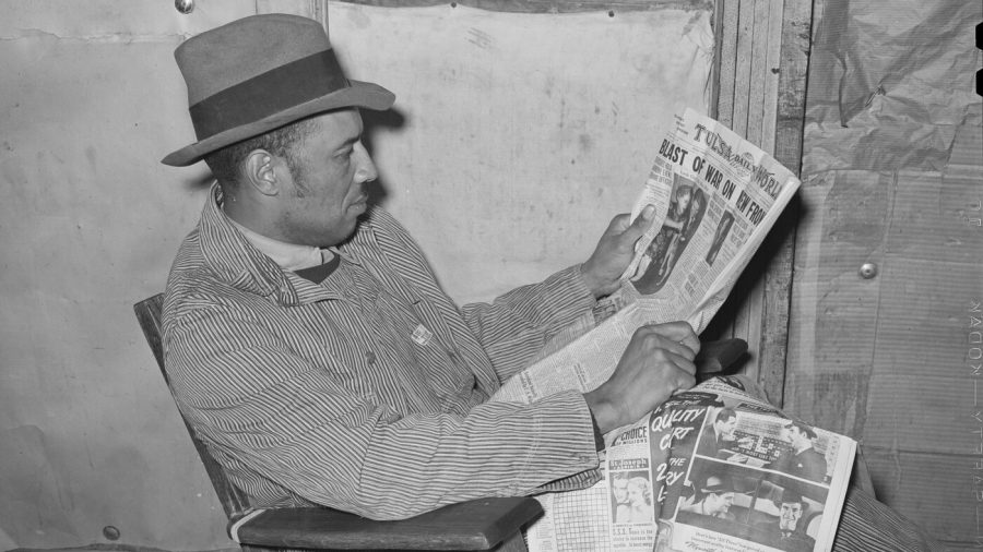 Tenant farmer reading newspaper. Creek County, Oklahoma. February 1940.